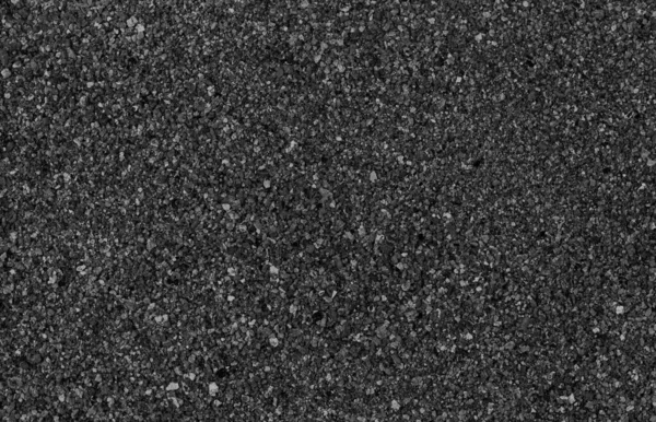 Gray small rocks ground texture. black small road stone background.