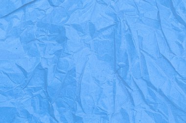 Sheet of crumpled light blue paper as background, top view