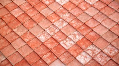 Üst üste binen kırmızı kil çatı fayanslarının yakın plan görüntüsü desenli geometrik desen oluşturur