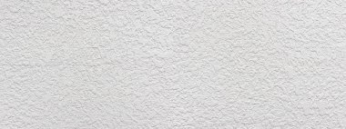 Beyaz kaba alçı duvarın yakın plan görüntüsü desenli arkaplan oluşturuyor