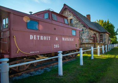 Passenger cars and old caboose stored at  historic Standish Michigan railroad depot
