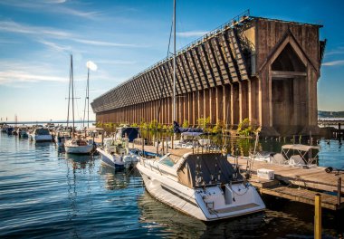 Boat Marina pier with sail boats tied next to old historic  iron ore ship loading dock
