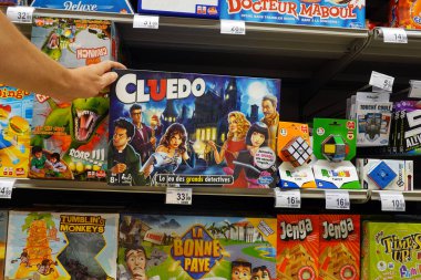 WALLONIA, BELGIUM AĞUSTOS 2022: Shopper, Carrefour hipermarketinin oyuncak bölümünde oynanan gizemli cinayet oyunu Cluedo 'nun Fransızca baskısını seçiyor.