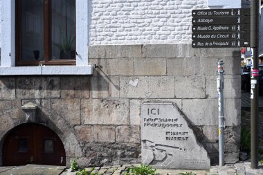 STAVELOT, BELGIUM - AUGUST 2023: In centre of the town a World War II memorial stone, French text: Ici fut arrete l'envahisseur, hiver 1944-45, translated: Here the invader was stopped, winter 1944 1945 clipart