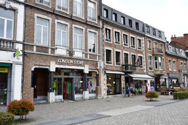 SPA, WALLONIA, BELGIUM - AUGUST 2023: Shops, hotel-restaurant and terrace on square, Place du Monument, in the center of Spa clipart
