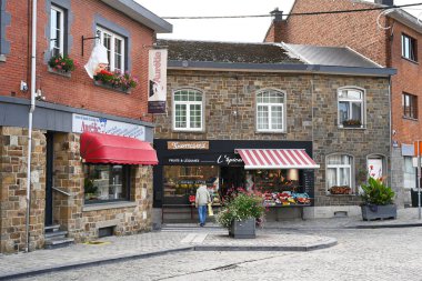 STAVELOT, WALLONIA, BELGIUM - AUGUST 2023: Hairdresser's shop and delicatessen shop in Stavelot, a town in the Belgian Ardennes clipart