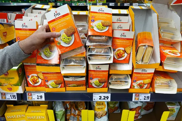 Stock image GERMANY - APRIL 2024: Store brand assortment of Gluten-free foods, packaged bread, buns, sandwiches, loafs in a Kaufland hypermarket.