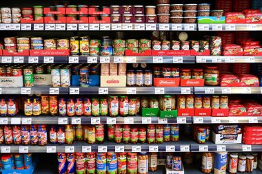 STRAELEN, ALMANY HAZİRAN 2024: ReWE süpermarketinde cam kavanozlar dolusu sosis ve et koruma ürünleriyle dolu koridor.