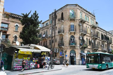 JERUSALEM, ISRAEL - 18 Mayıs 2023: tarihi binaları, bir satış standı ve bir Egged şehir otobüsü olan Jaffa Caddesi. Rehov Yafo, Kudüs 'ün en uzun ve en eski caddelerinden biri.
