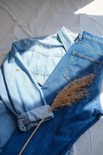 Denim jacket pocket with dried pampas grass on white background