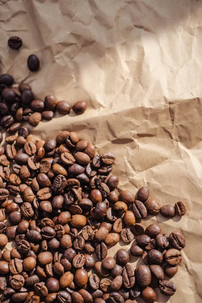 Coffee beans on brown paper background, can be used as a background