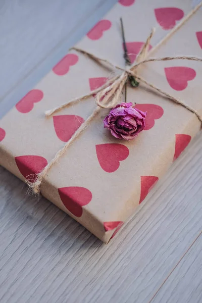 Geschenkverpackung Bastelpapier Mit Roten Herzen Auf Einem Hölzernen Hintergrund — Stockfoto