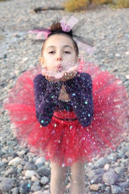 Little dancer in a pink tutu dancing outdoors clipart