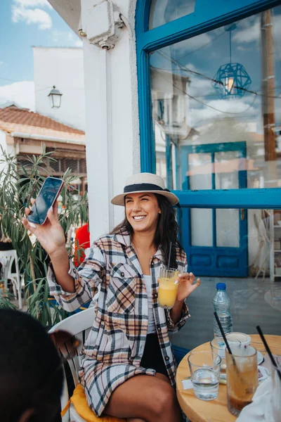 Güzel Turist Kız Telefonunu Birine Gösteriyor Kafede Otururken Gülümsüyor — Stok fotoğraf