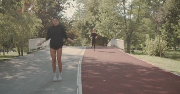 Young Couple Exercise Together Park Girl Jumping Rope Boy Running — Stock Video