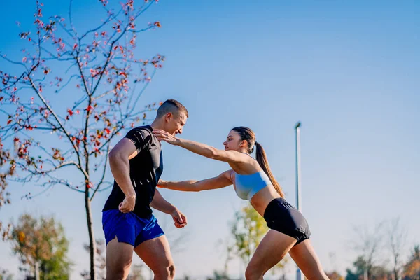 Homem Musculoso Apoiando Sua Namorada Enquanto Ela Está Exercitando — Fotografia de Stock