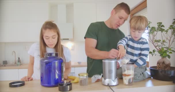 Son Father Putting Protein Powder Banana Smoothie While Son Sitting — Stockvideo
