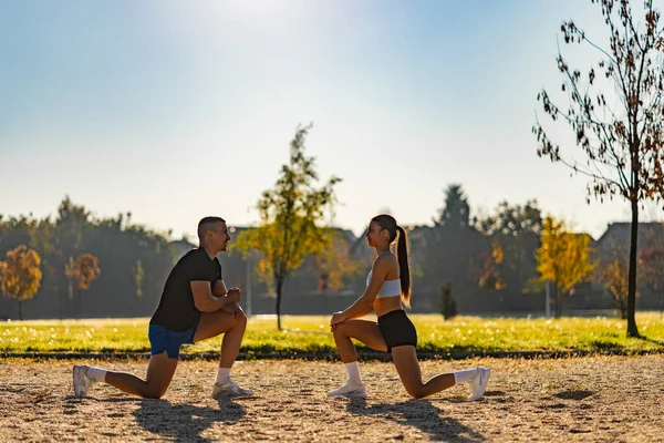 Best Friends Exercising Together Park Sunny Day Stretching Legs Having — Stock fotografie