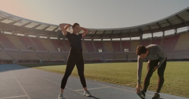 Sabahleyin Stadyuma Koşmadan Önce Siyah Elbiseli Genç Bir Çift Isınıyor — Stok video