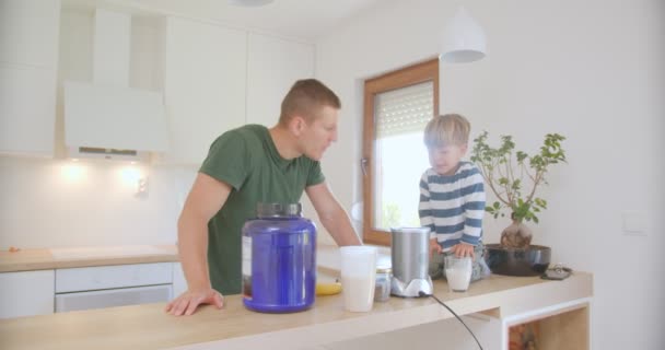Father Clapping Smoothie Made His Cute Little Son Sitting Kitchen — Stockvideo