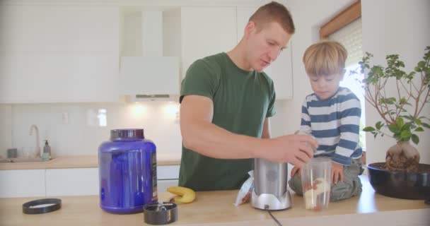 Father Son Making Smoothie Putting Chia Seeds Smoothie While Son — Stockvideo