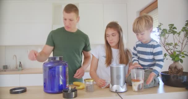 Father Putting Some Protein Powder Smoothie While Mother Son Looking — Wideo stockowe