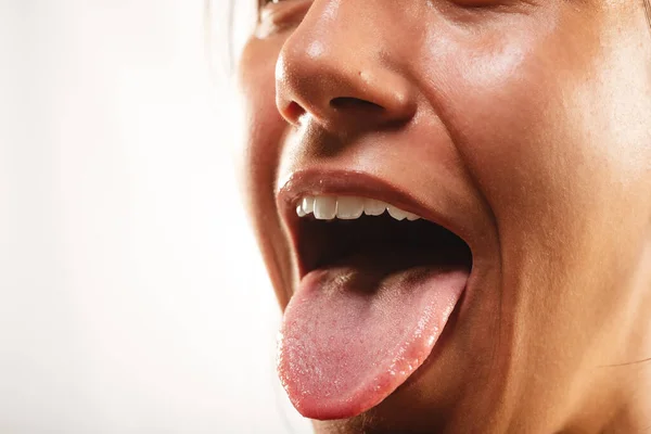 Close up of girls mouth open with her tongue out at the studio