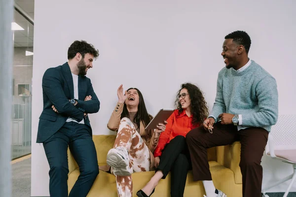 Four Attractive Business Colleagues Having Fun Laughing While Sitting Yellow — Stock Photo, Image