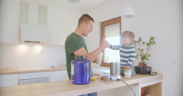 Father Son Liking Smoothie Made While Son Sitting Kitchen Counter — Stock Video