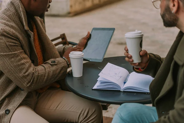 两个不同的同事在户外喝茶 讨论生意 黑人在平板电脑上解释什么 — 图库照片
