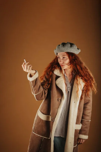 Ginger Dívka Dívá Cigarety Whiles Stojící Studiu — Stock fotografie