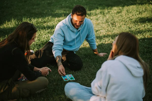 Close Three Friends Playing Ludo Grass While Sitting Park — Stock Photo, Image