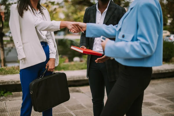 stock image Close up of business colleagues shaking hands while standing at the park