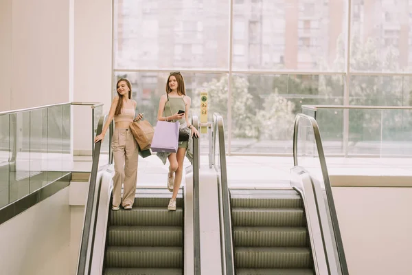 Two Beautiful Girls Shopping Bags Going Escalator — Stock fotografie