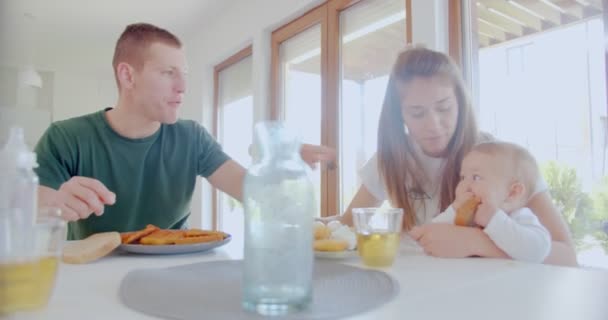 Vackra Föräldrar Tittar Sin Dotter Medan Hon Äter Bit Bröd — Stockvideo