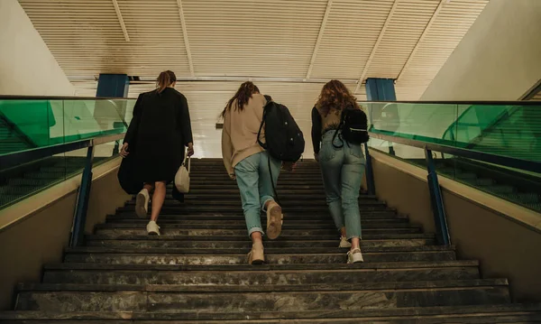 三个女孩上楼走向火车站的背景照片 他们提着袋子去旅行 — 图库照片