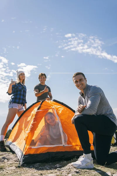 Grupo Cuatro Personas Acampando Posando Con Carpa Naranja Montaña — Foto de Stock