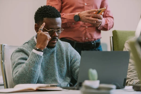 Hombre Negocios Guapo Pensando Mirando Portátil Mientras Está Sentado Escritorio —  Fotos de Stock