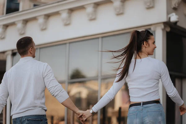 市内中心部で手を取りながら歩く美しいカップル — ストック写真