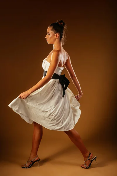 Beautiful Girl Holding Her White Dress While Walking Studio Light — Stock Photo, Image