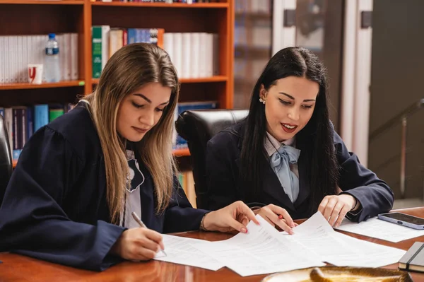 Two Young University Graduates Wearing Gown Signing Filling Out Documents — Stock Photo, Image