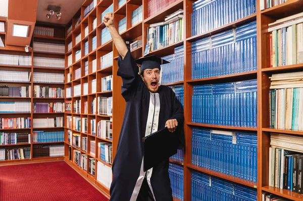 Shocked Graduate Wearing His Cap Gown Pumps His Fist Air — Stock Photo, Image