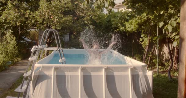 Young Kid Having Fun Pool Backyard Summer Splashing Water Slow — Stock Video