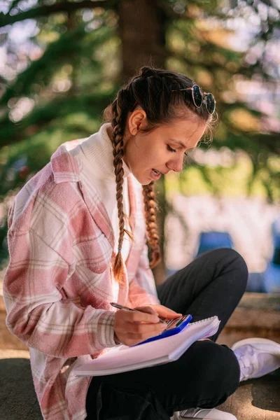 Wunderschöne Brünette Mädchen Mit Taschenrechner Beim Schreiben Mathe Hausaufgaben Nach — Stockfoto