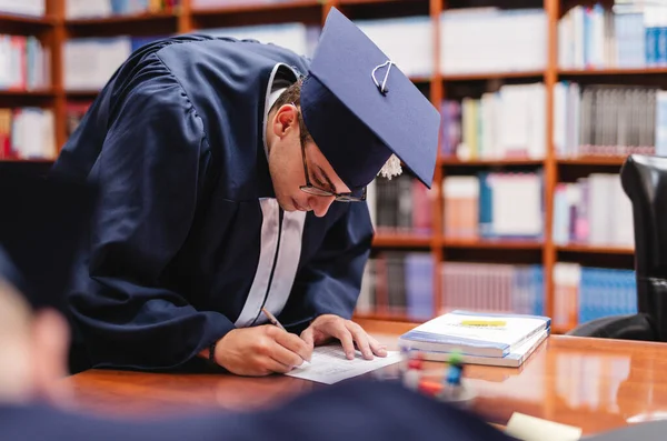 Young Male Graduate Writing His Personal Information Signature Paper Form — Stock Photo, Image