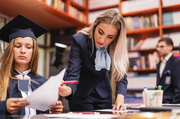 Young Attractive Secretary Overlooking Graduation Student Helping Her Finish Document — Stock Photo, Image