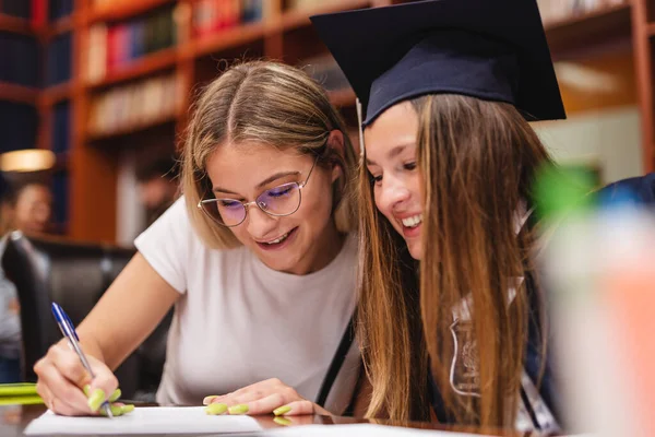 Two Young Beautiful Graduates Filling Out Forum Together University Library — Stock Photo, Image