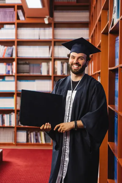 Excited Graduate Wearing Cap Gown Holding His Bachelor Degree — Stock Photo, Image