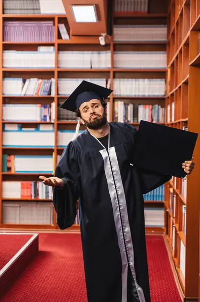 Young Graduate Wearing His Cap Gown Looking Sad While Holding — Stock Photo, Image