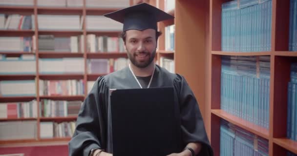 졸업장이 가능하다는 보여주는 자랑스럽게 도서관에서 자신의 졸업장을 — 비디오